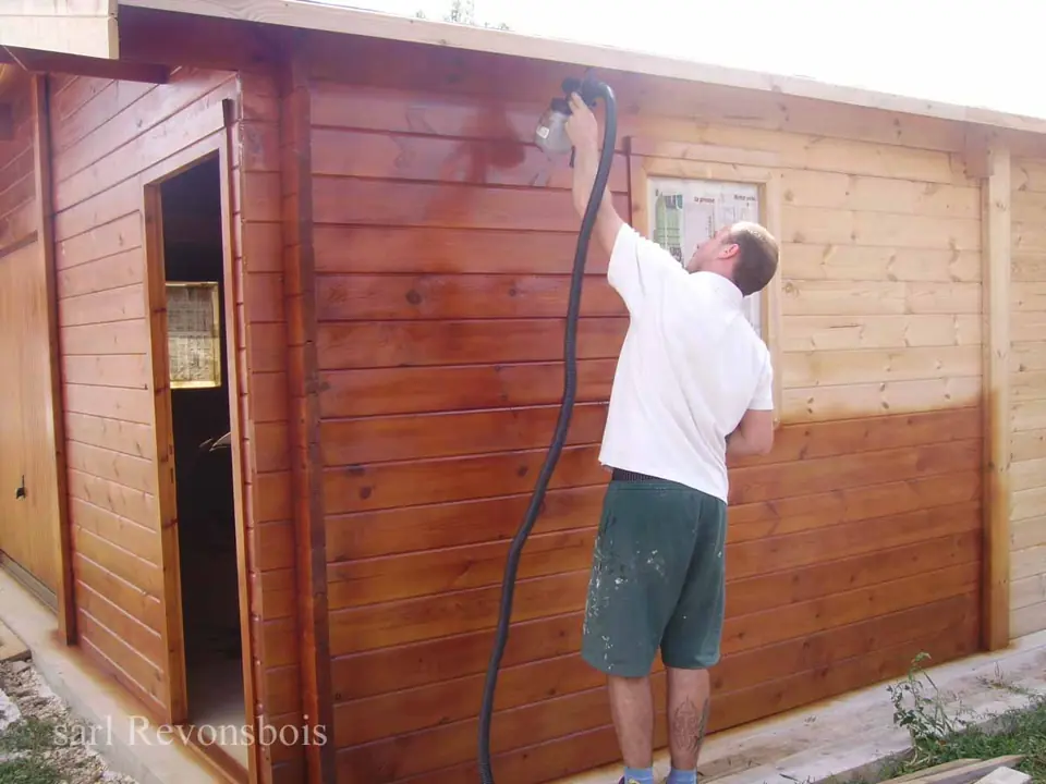 Application de lasure sur garage en madriers