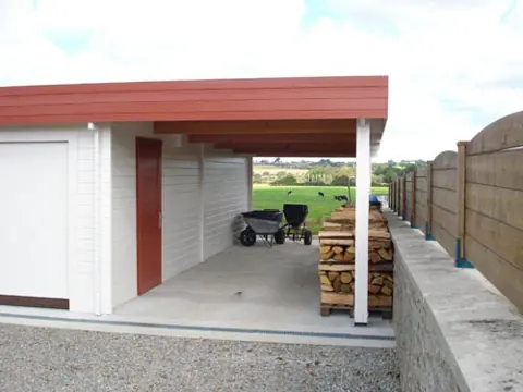 Carport accolé à un garage blanc toit plat